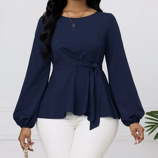 Navy blue long-sleeve top with a tie detail worn by a person on a white background