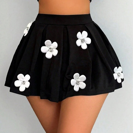 Black skirt with white floral appliqués on a gray background