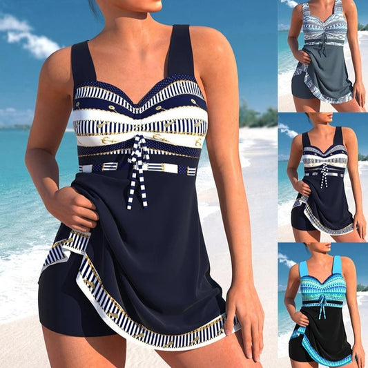 Woman wearing a navy blue and white patterned tankini set on a beach.